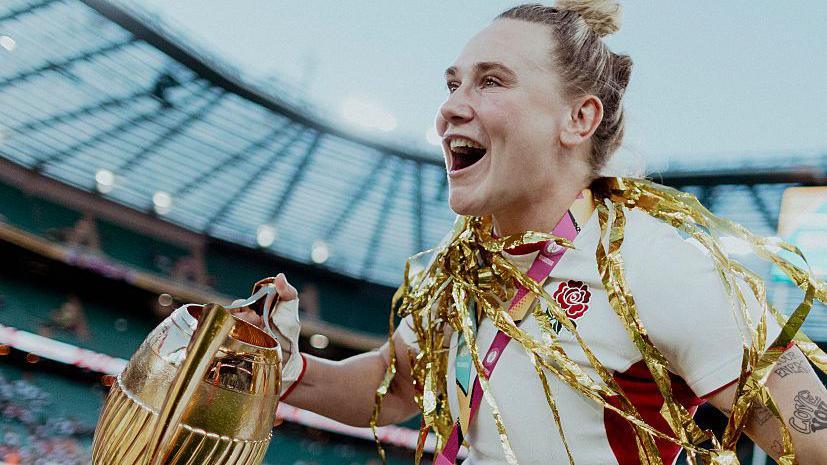 Meg Jones lifting the Rugby World Cup trophy